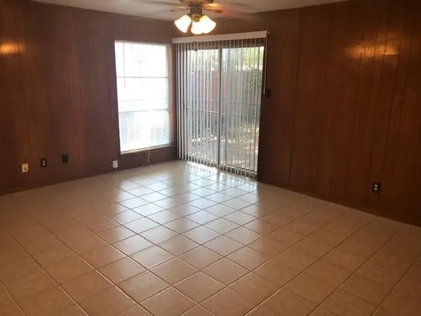 an empty room with windows and entrance