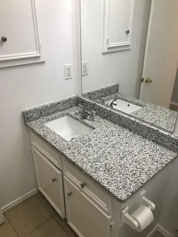 a bathroom with a sink and vanity