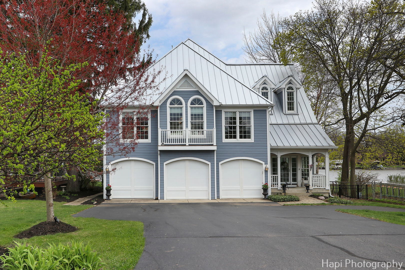 1828 Orchard Beach Road McHenry, IL 60050 - Photo 67 of 80 a front view of a house with a garden and trees