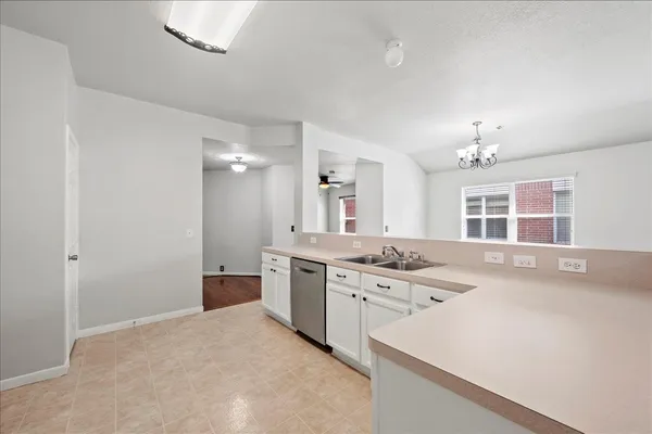 a spacious bathroom with a granite countertop sink and a mirror