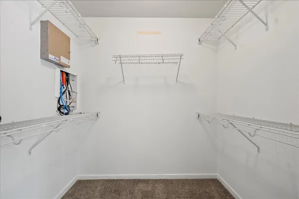 an empty room with fan and windows