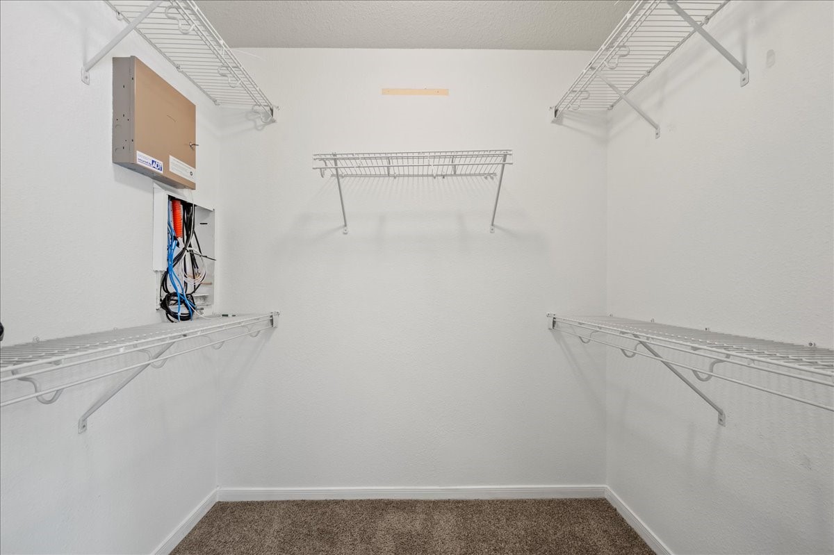 17535 Prospect Meadows Drive Houston, TX 77095 - Photo 19 of 39 Adjacent to the bedroom, the generous walk-in closet provides ample storage space, featuring built-in shelves and hanging areas to keep clothing and accessories organized.