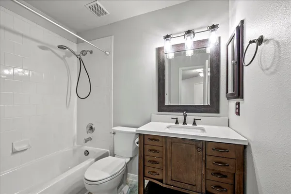 an empty room with closet and a chandelier fan