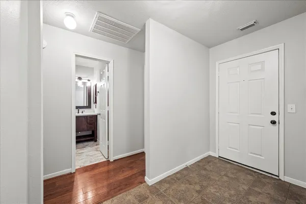 a view of a hallway with wooden floor