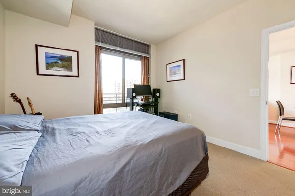 a bedroom with a bed and a painting on the wall