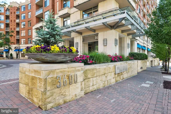 a front view of building with flowers