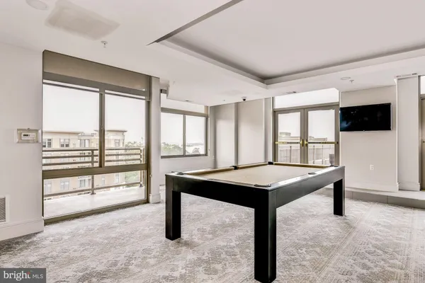 a large living room with furniture and a large window