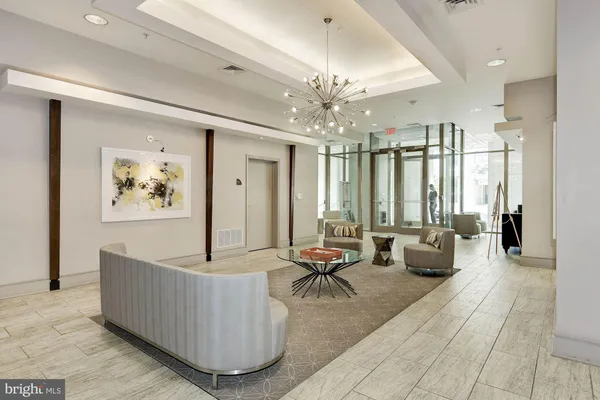 a living room with furniture and a chandelier