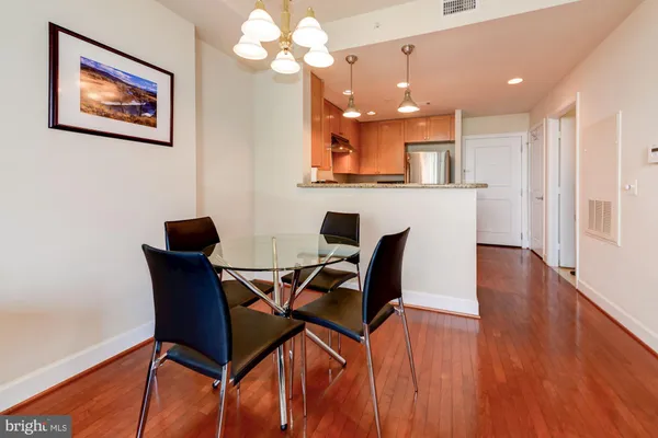 a view of a dining room with furniture and wooden floor