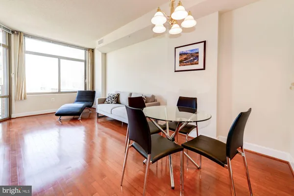 a workspace with wooden floor and a window
