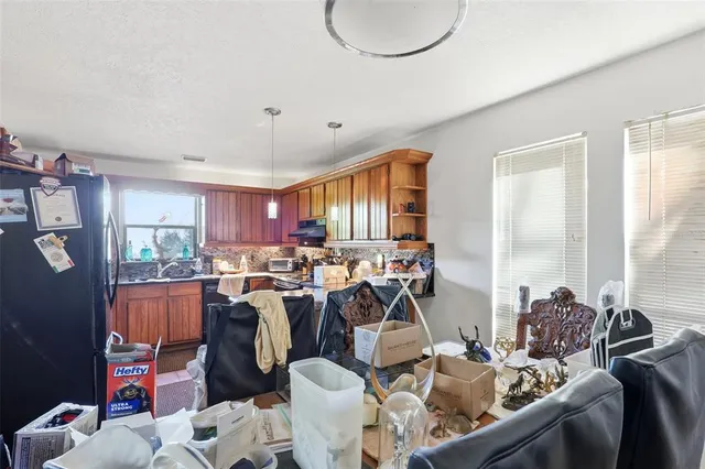 a living room with furniture a rug and a book shelf