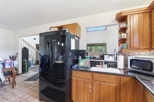a view of a yard with plants and trees