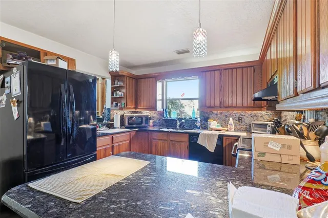 a kitchen with lots of counter top space appliances and a window