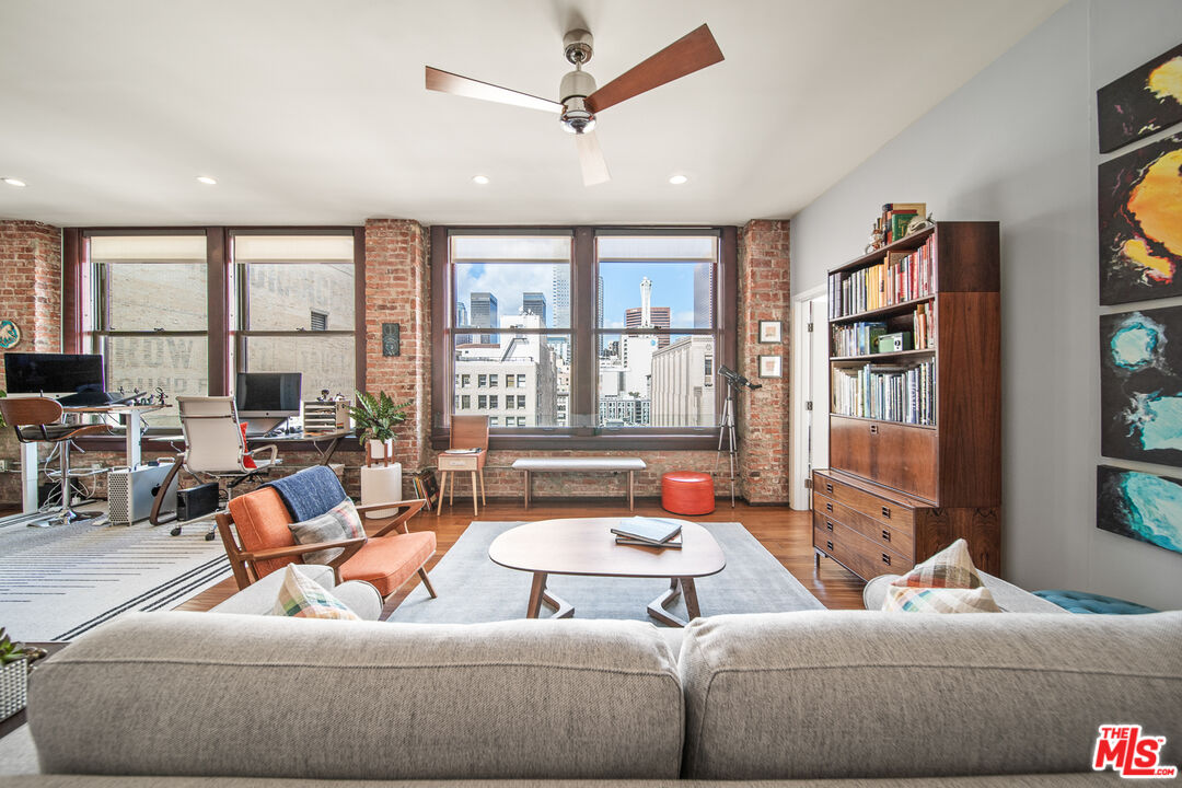 460 South Spring Street, Unit 1205 Los Angeles, CA 90013 - Photo 13 of 37 a living room with furniture and a large window
