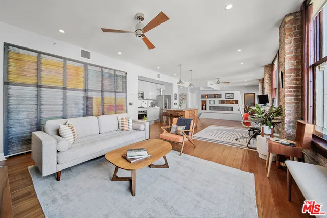 a view of a living room filled with furniture and a window