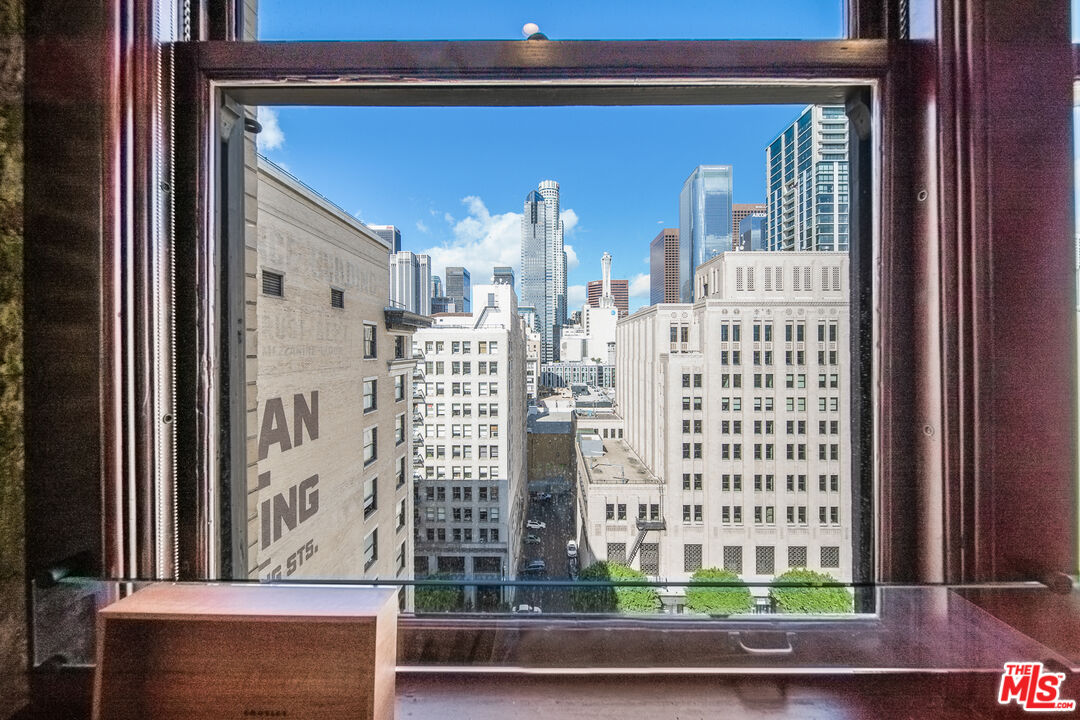 460 South Spring Street, Unit 1205 Los Angeles, CA 90013 - Photo 15 of 37 a view of a living room filled with furniture and a window
