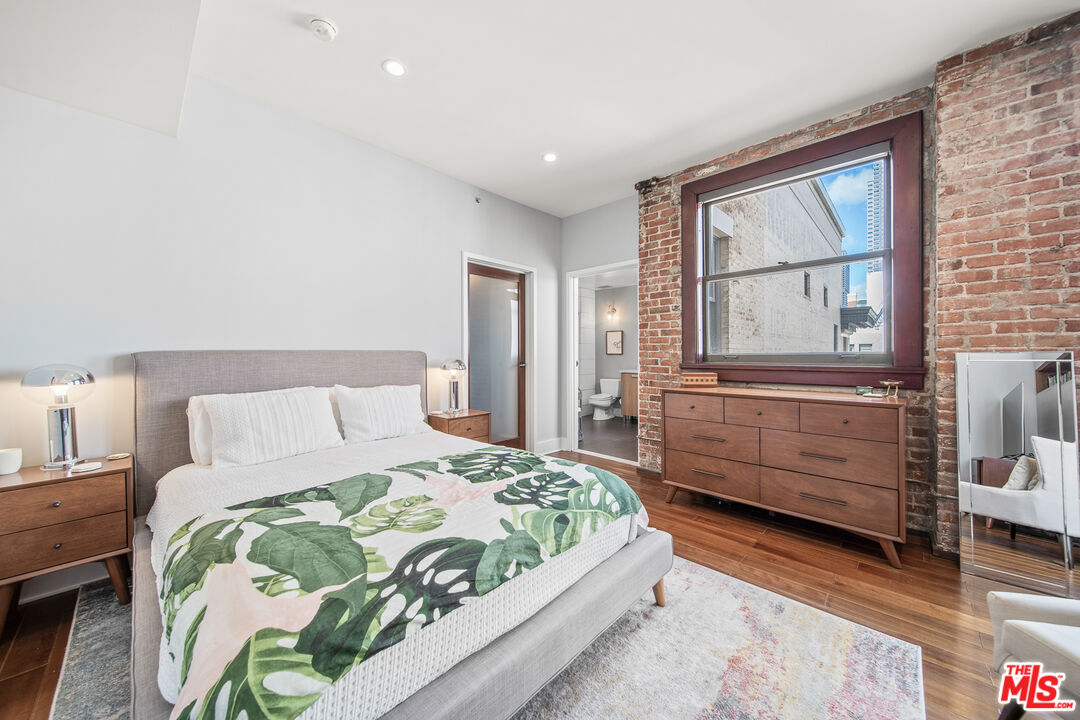 460 South Spring Street, Unit 1205 Los Angeles, CA 90013 - Photo 17 of 37 a bedroom with a bed and a window