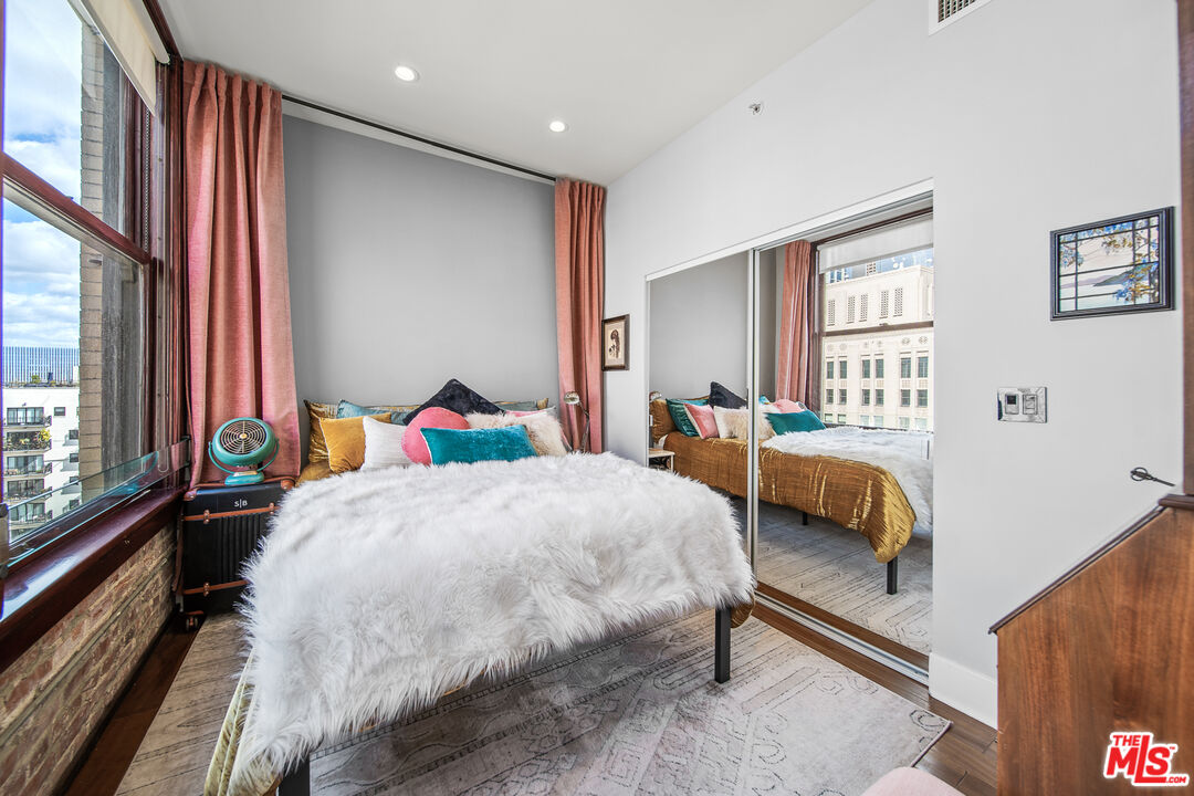 460 South Spring Street, Unit 1205 Los Angeles, CA 90013 - Photo 20 of 37 a bedroom with a bed and a large window