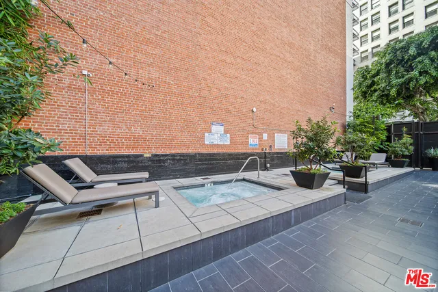a view of a patio with chairs and potted plants