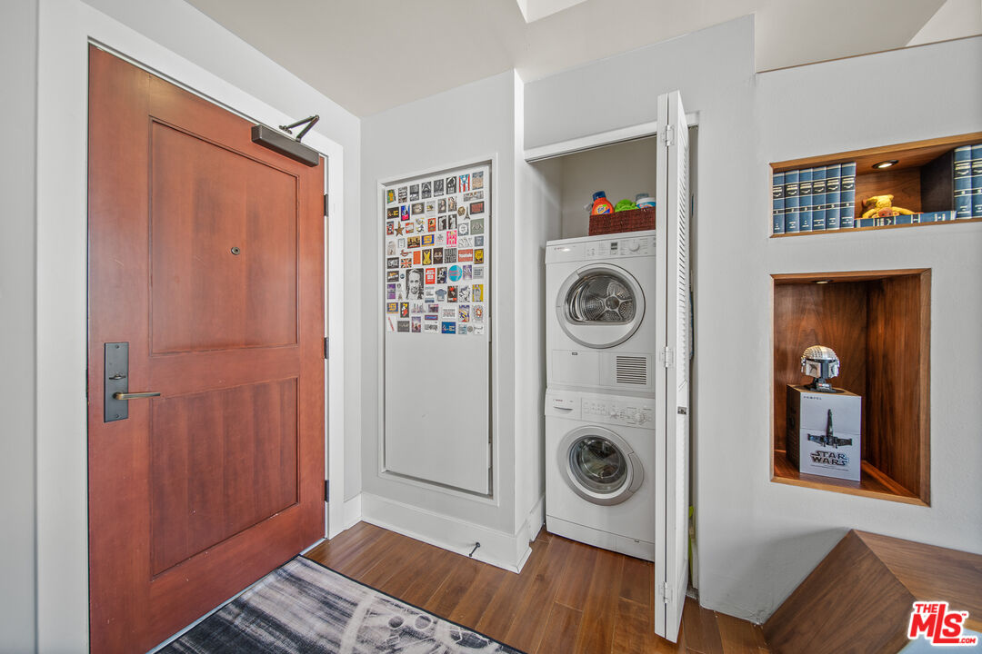460 South Spring Street, Unit 1205 Los Angeles, CA 90013 - Photo 6 of 37 a view of a bedroom with washer and dryer