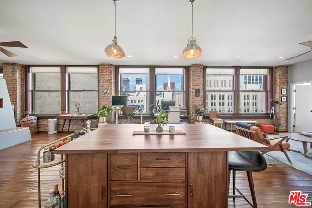 a kitchen with stainless steel appliances a stove a refrigerator and a sink