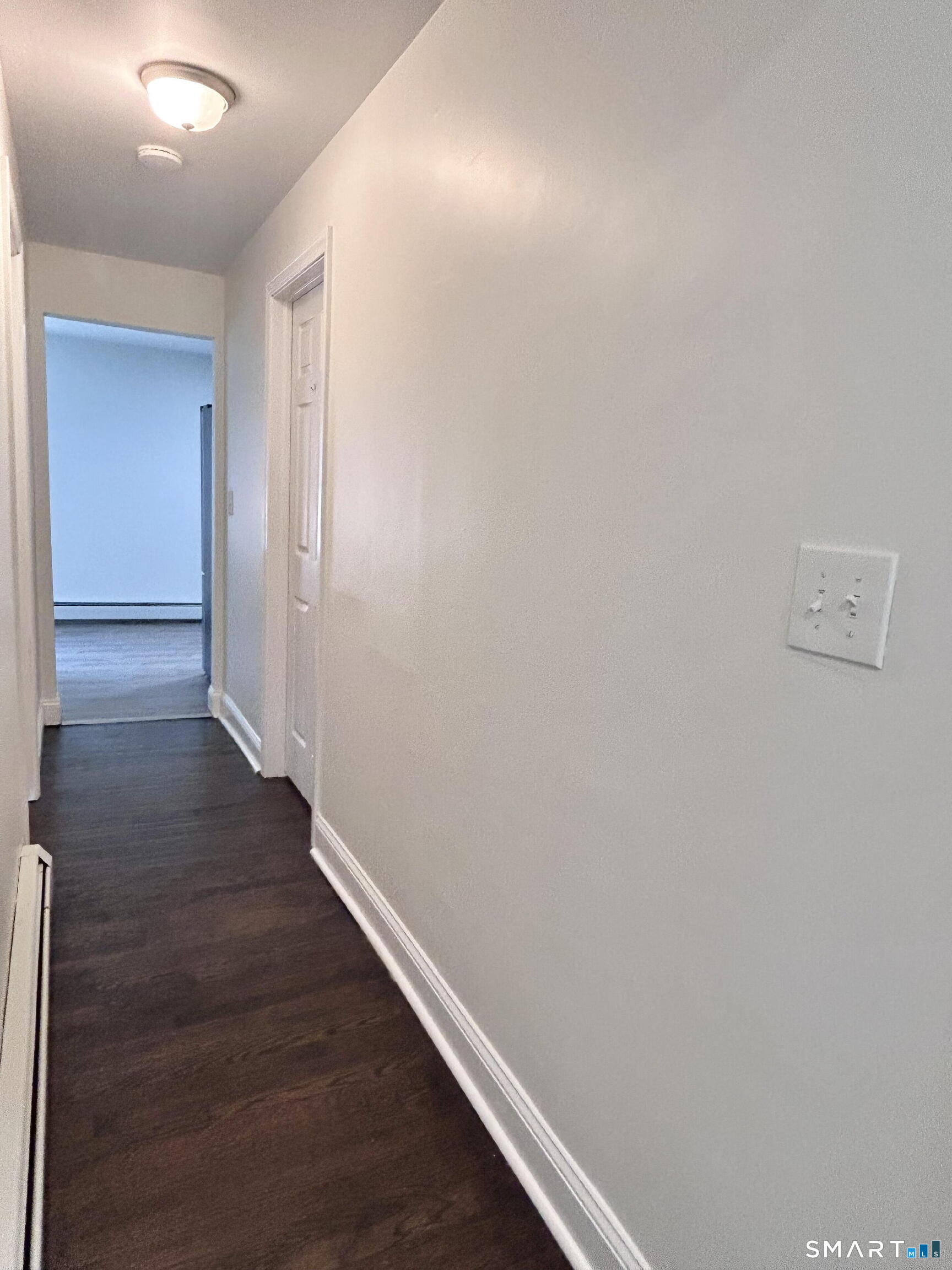 54 Roath Street Norwich, CT 06360 - Photo 15 of 16 a view of a hallway with wooden floor
