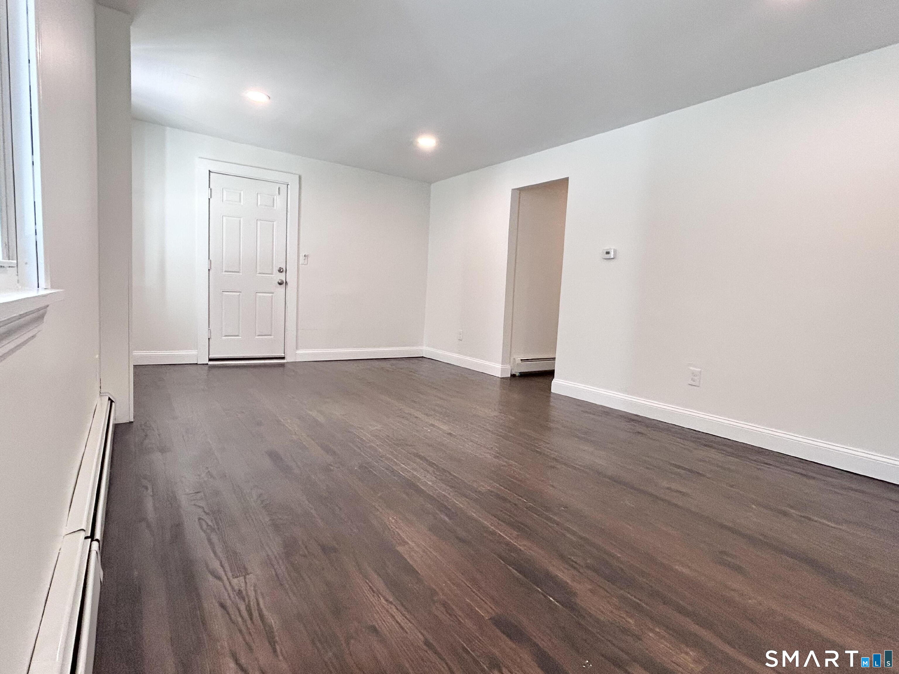 54 Roath Street Norwich, CT 06360 - Photo 6 of 16 a view of an empty room with wooden floor