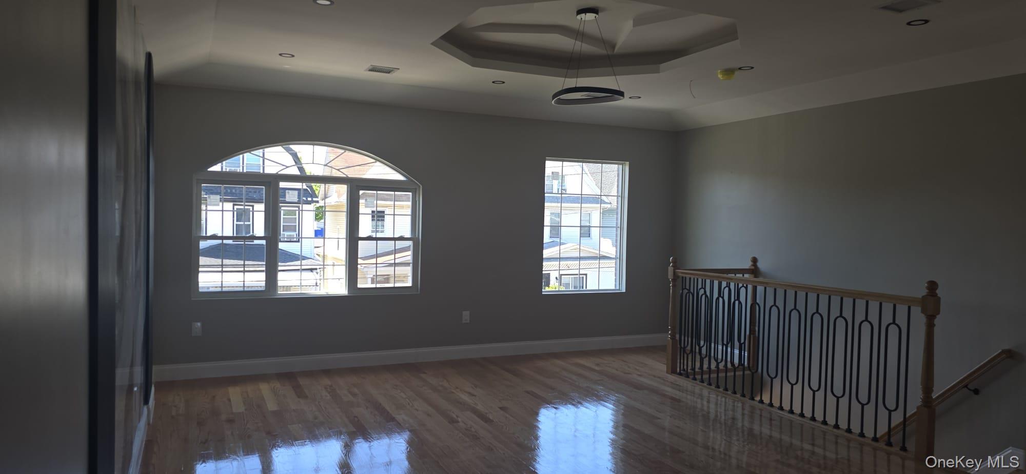 108-33 164th Street Queens, NY 11433 - Photo 4 of 20 a view of empty room with wooden floor and fan