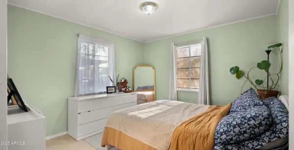 a bedroom with a bed and a window