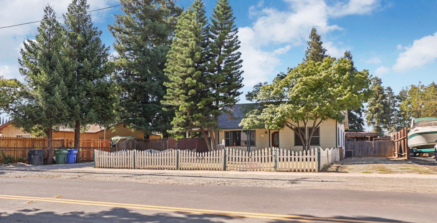 916 Elm Avenue Modesto, CA 95351 - Photo 2 of 52 2. Wider front view with driveway Room to arrive, room to breathe, and plenty of space for the life that happens between the front gate and the front door.