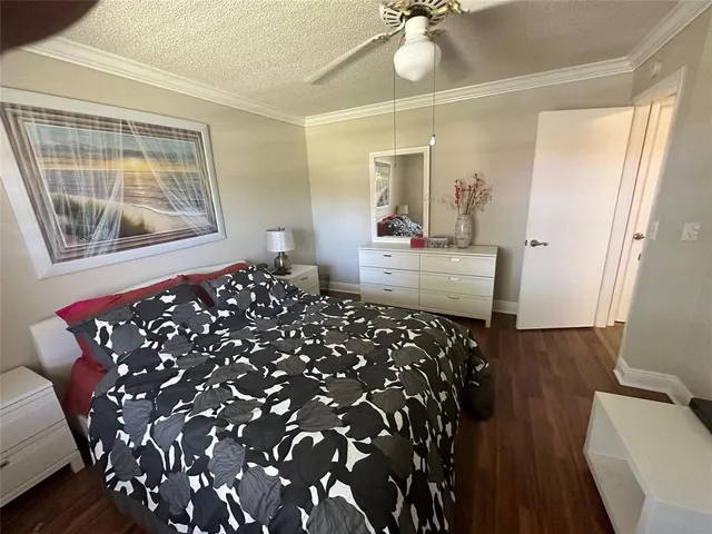 a bedroom with bed and wooden floor