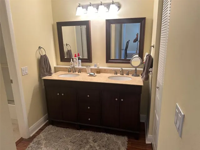 a bathroom with a double vanity sink and a mirror