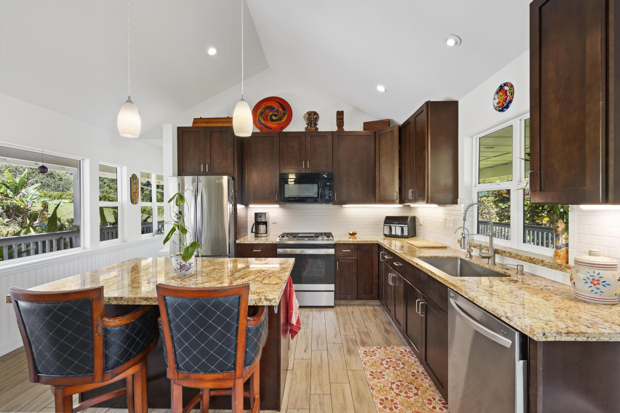 896 Hoomalolo Place, Unit B Haiku, HI 96708 - Photo 18 of 44 a kitchen with stainless steel appliances granite countertop a sink and a refrigerator