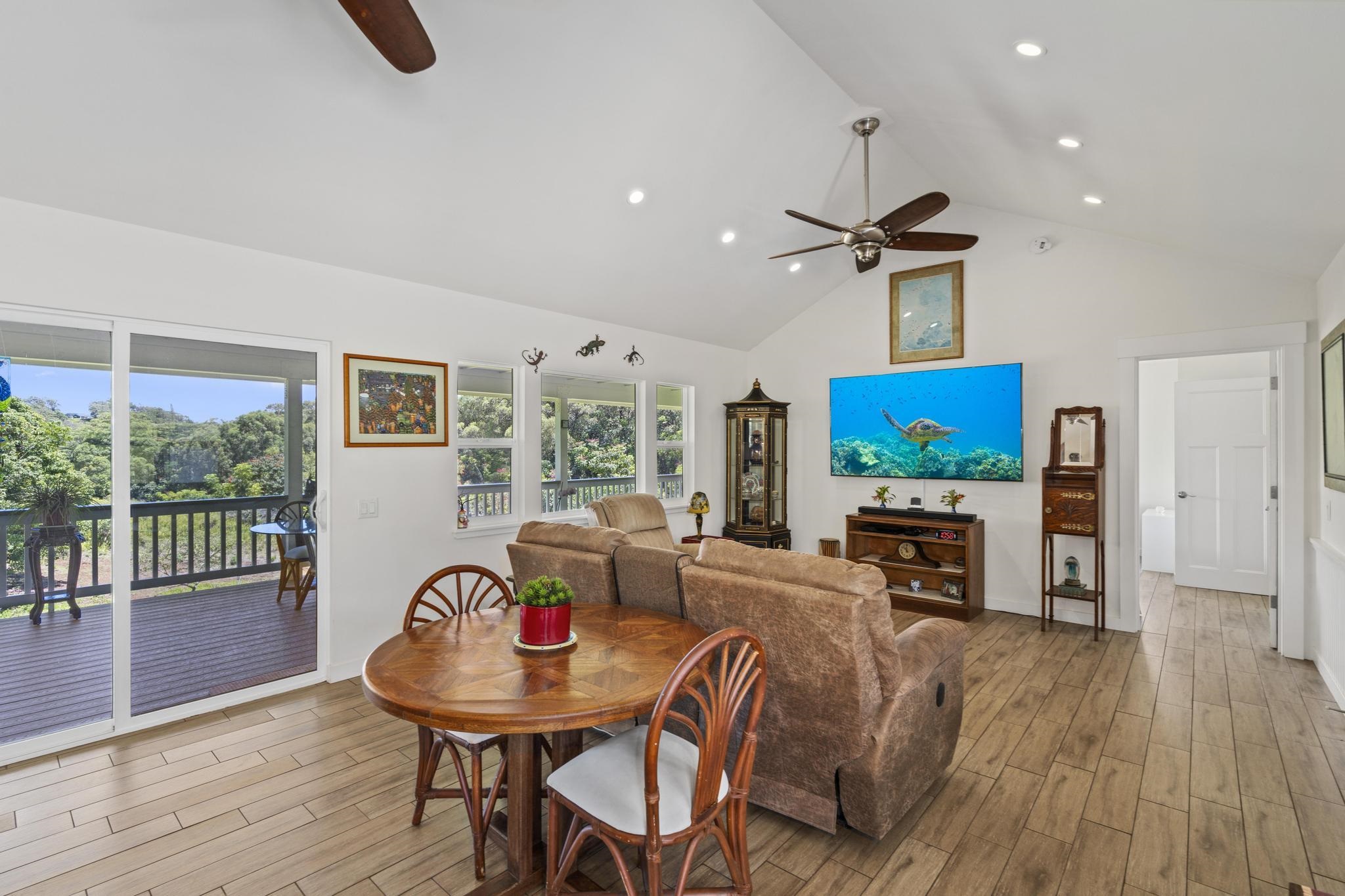 896 Hoomalolo Place, Unit B Haiku, HI 96708 - Photo 20 of 44 a living room with furniture a window and a flat screen tv