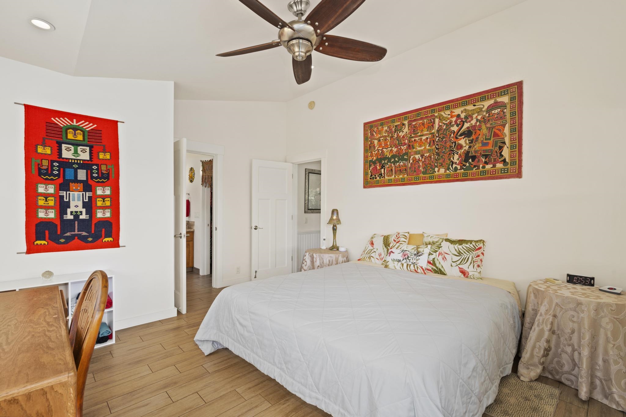 896 Hoomalolo Place, Unit B Haiku, HI 96708 - Photo 22 of 44 a bedroom with a bed and a painting on the wall