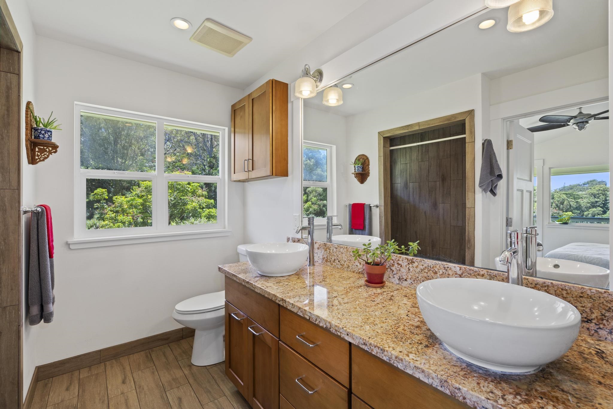 896 Hoomalolo Place, Unit B Haiku, HI 96708 - Photo 26 of 44 a bathroom with a granite countertop sink and a mirror