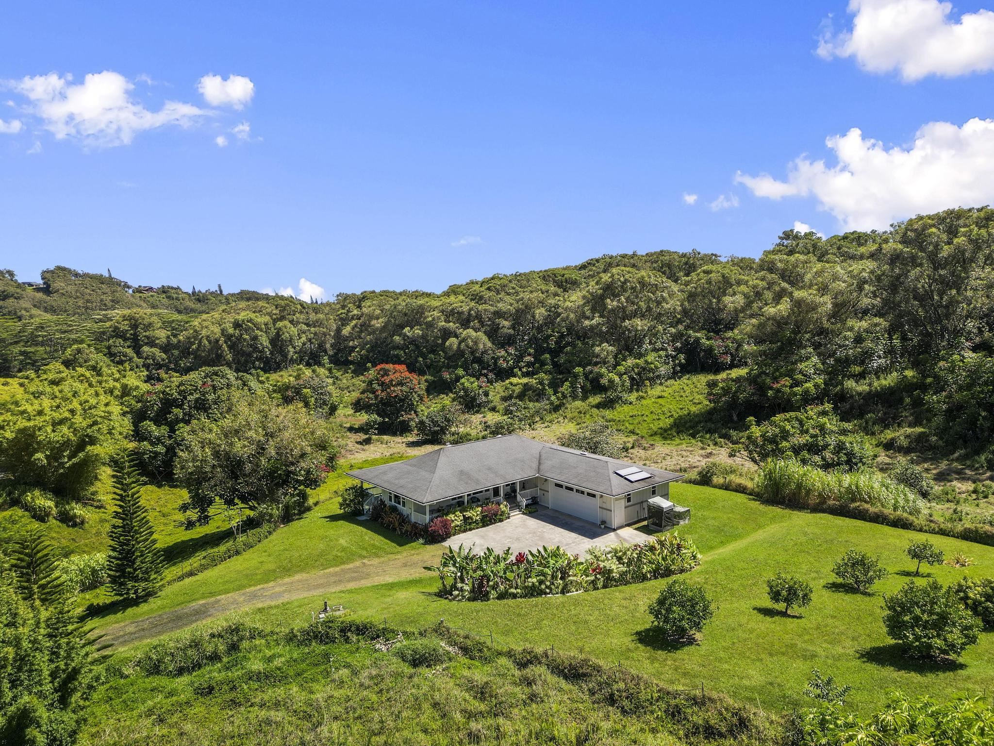 896 Hoomalolo Place, Unit B Haiku, HI 96708 - Photo 3 of 44 a view of a house with a big yard