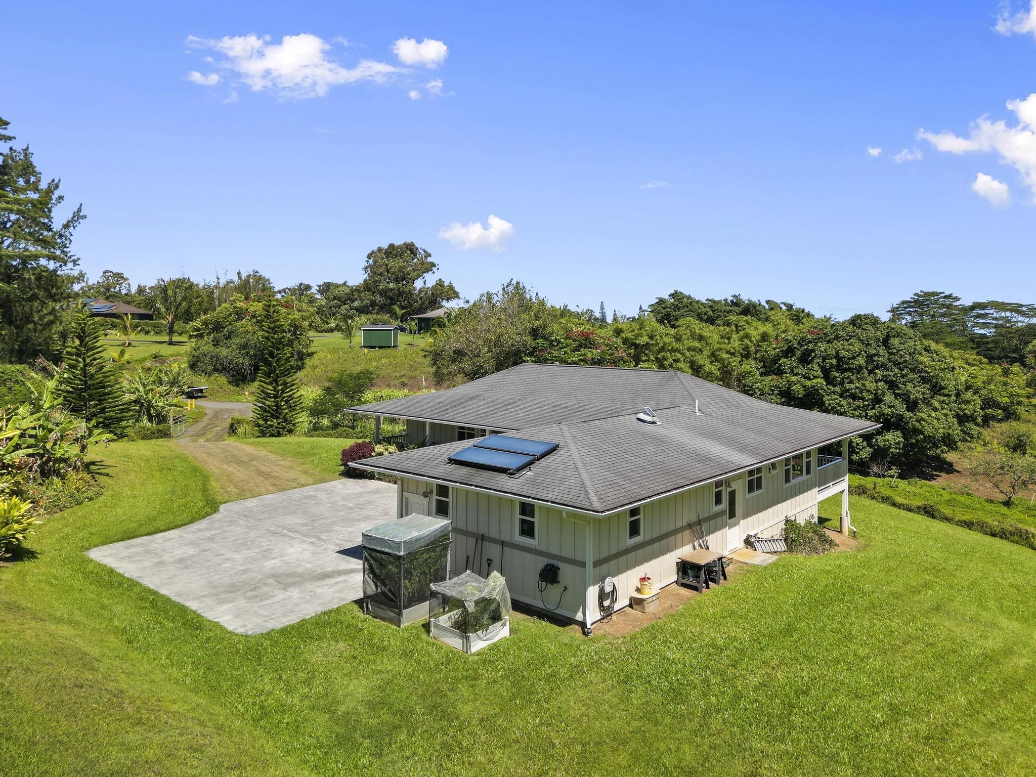 896 Hoomalolo Place, Unit B Haiku, HI 96708 - Photo 43 of 44 an aerial view of a house with backyard outdoor seating and green space