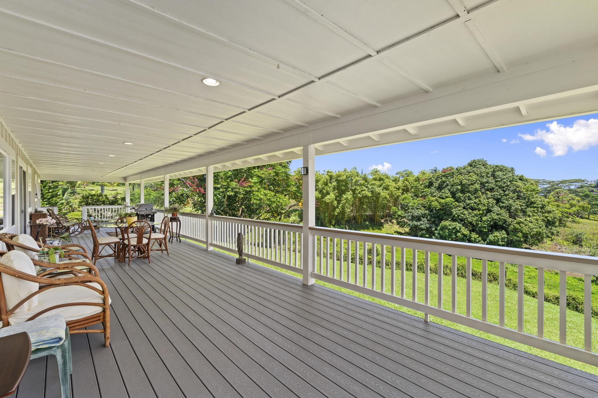 896 Hoomalolo Place, Unit B Haiku, HI 96708 - Photo 7 of 44 a view of a patio with table and chairs and wooden floor