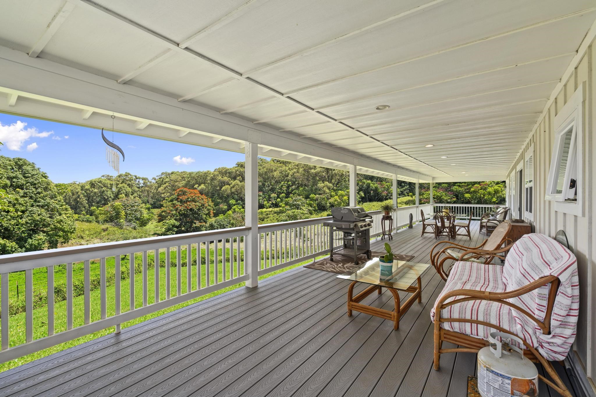 896 Hoomalolo Place, Unit B Haiku, HI 96708 - Photo 9 of 44 a view of a balcony with chairs and wooden floor