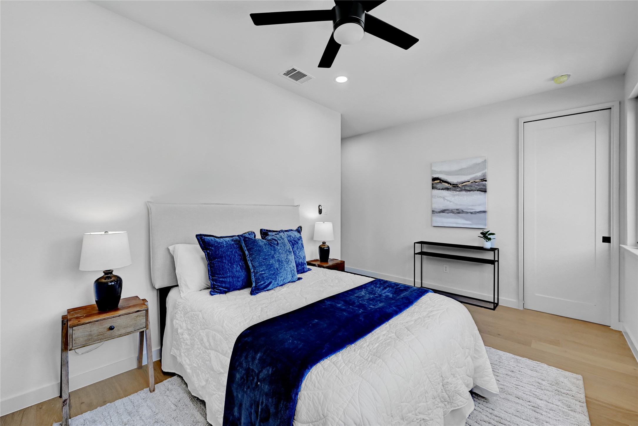 2717 Lyons Road, Unit 1 Austin, TX 78702 - Photo 18 of 34 Bedroom featuring light wood-type flooring, ceiling fan, and recessed lighting