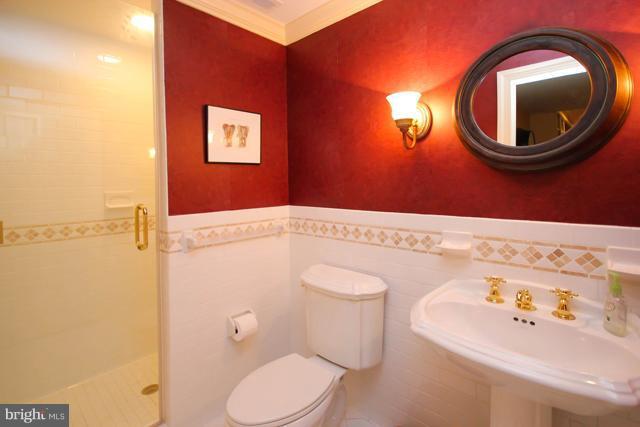 9001 Brickyard Road Potomac, MD 20854 - Photo 22 of 30 a bathroom with a sink mirror vanity and toilet
