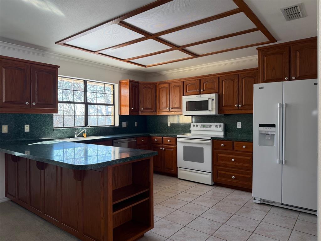 150 Timberidge Lake Road Graham, TX 76450 - Photo 9 of 25 a kitchen with granite countertop a stove cabinets and stainless steel appliances