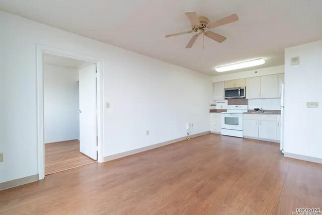 a view of a kitchen with a sink and a refrigerator