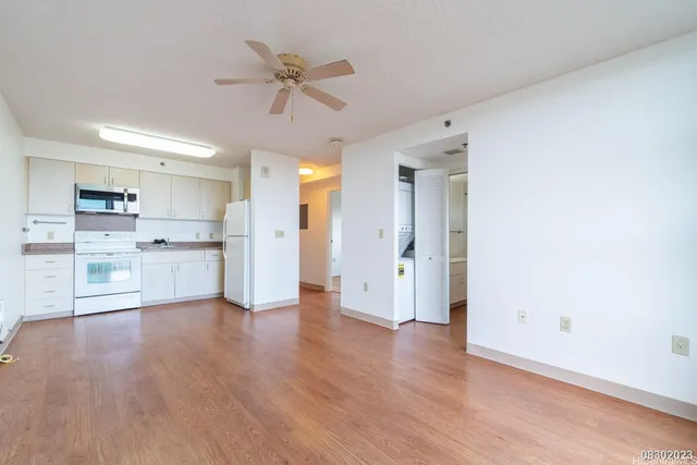 a view of a kitchen with wooden floor and a sink