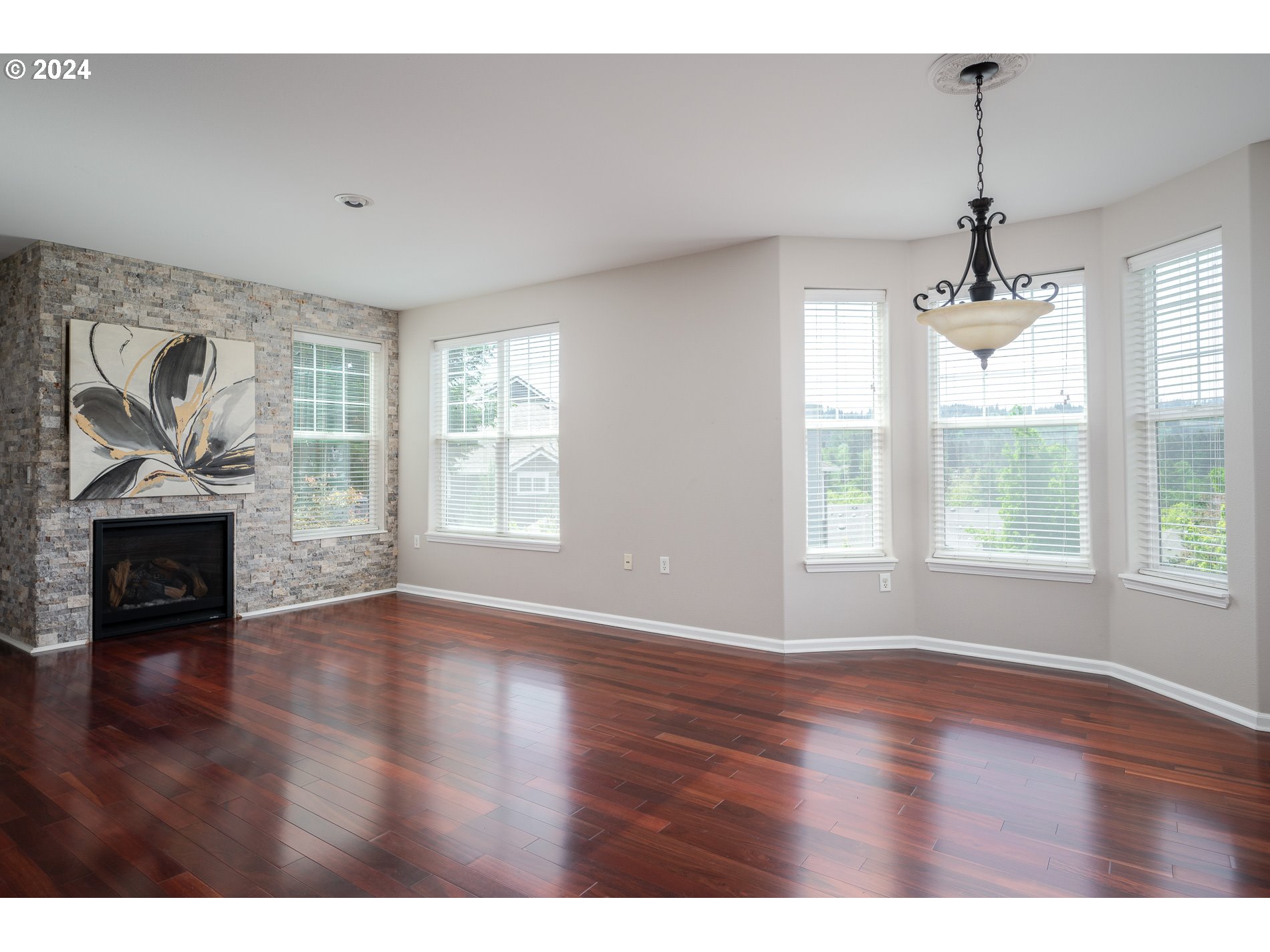 2395 Snowberry Ridge Court West Linn, OR 97068 - Photo 1 of 37 a view of an empty room with a window and wooden floor