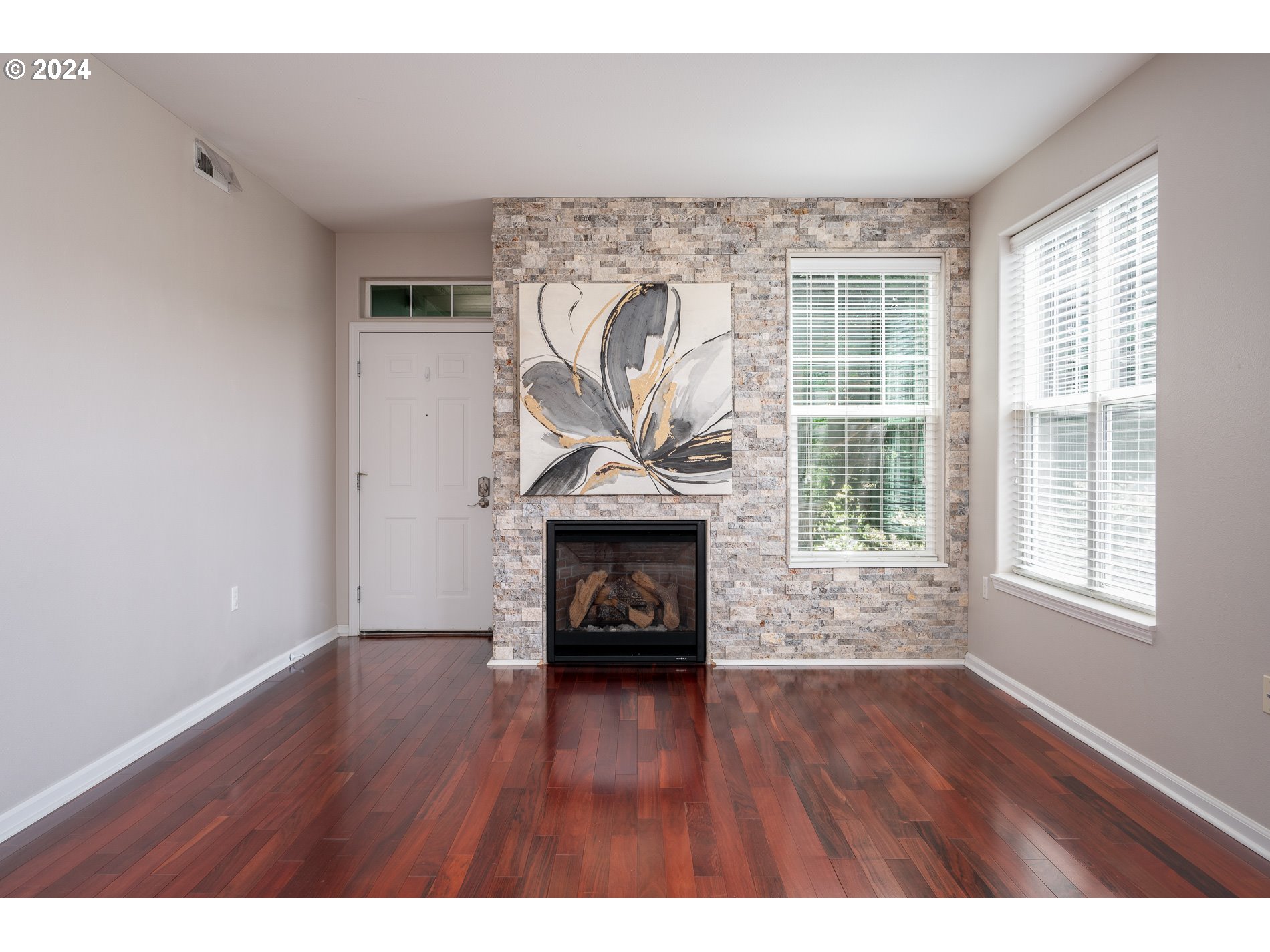 2395 Snowberry Ridge Court West Linn, OR 97068 - Photo 4 of 37 a living room with a fireplace and wooden floor