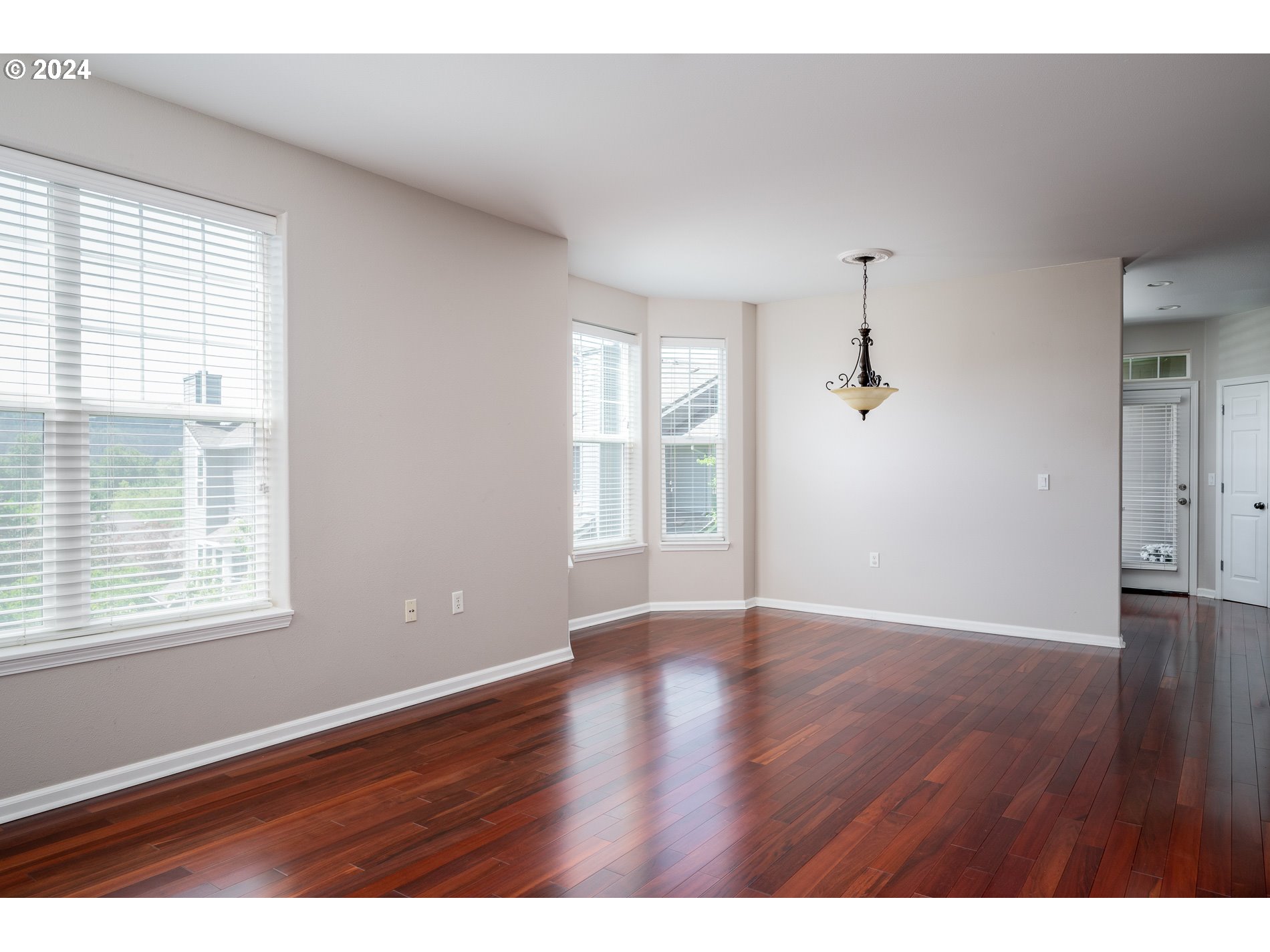 2395 Snowberry Ridge Court West Linn, OR 97068 - Photo 8 of 37 a view of an empty room with wooden floor and a window
