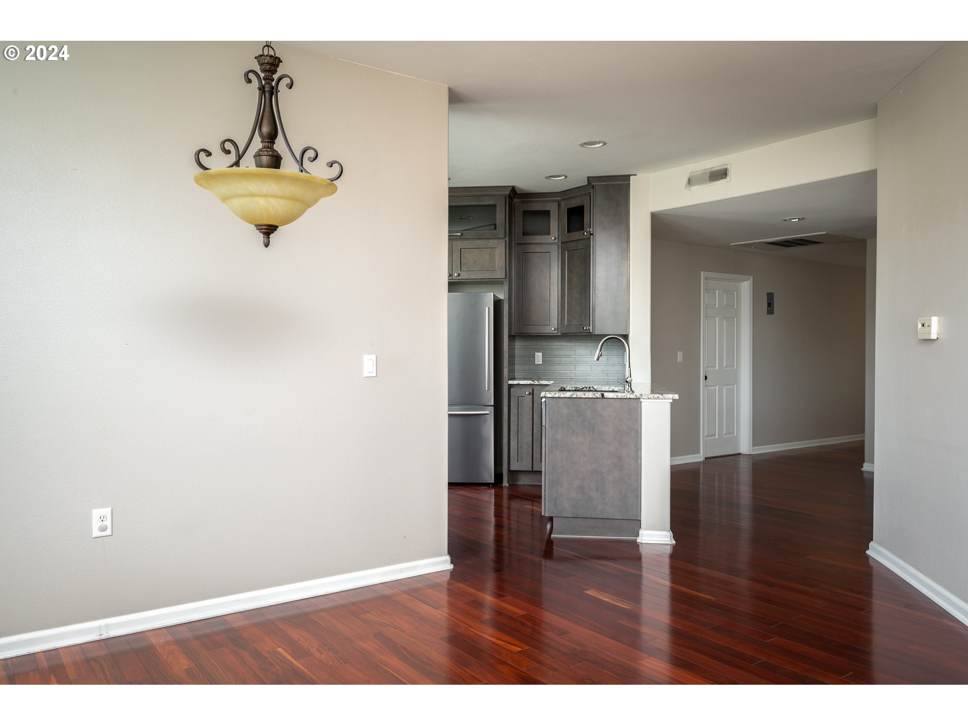 2395 Snowberry Ridge Court West Linn, OR 97068 - Photo 9 of 37 a view of a kitchen with wooden floor and a refrigerator
