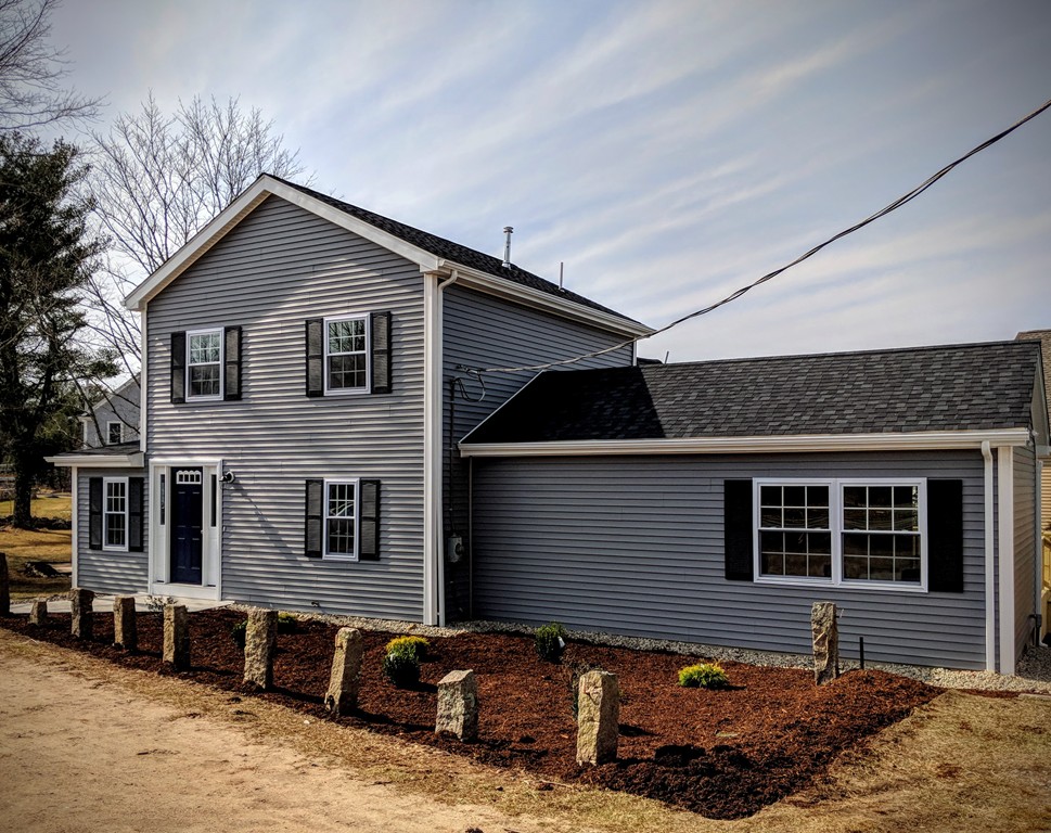 396 Reed Road Dartmouth, MA 02747 - Photo 1 of 13 a front view of a house with a yard